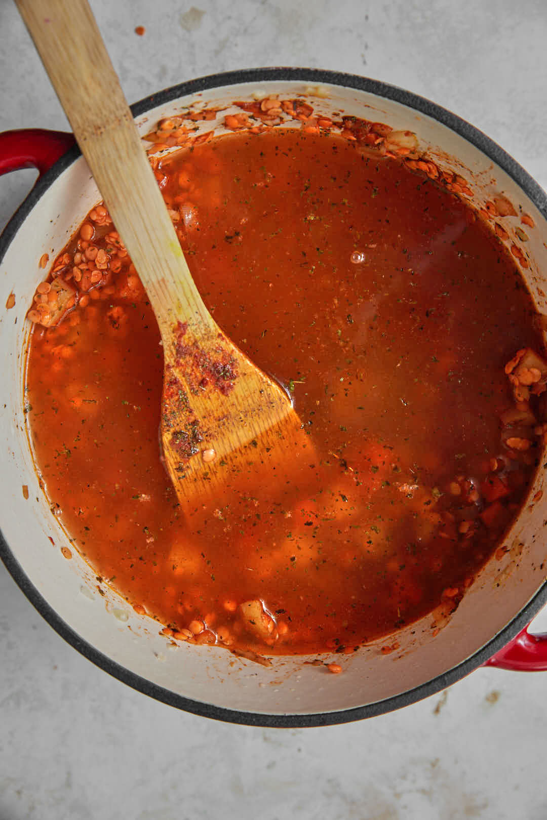 water and stock cubes added to lentils in a saucepan.