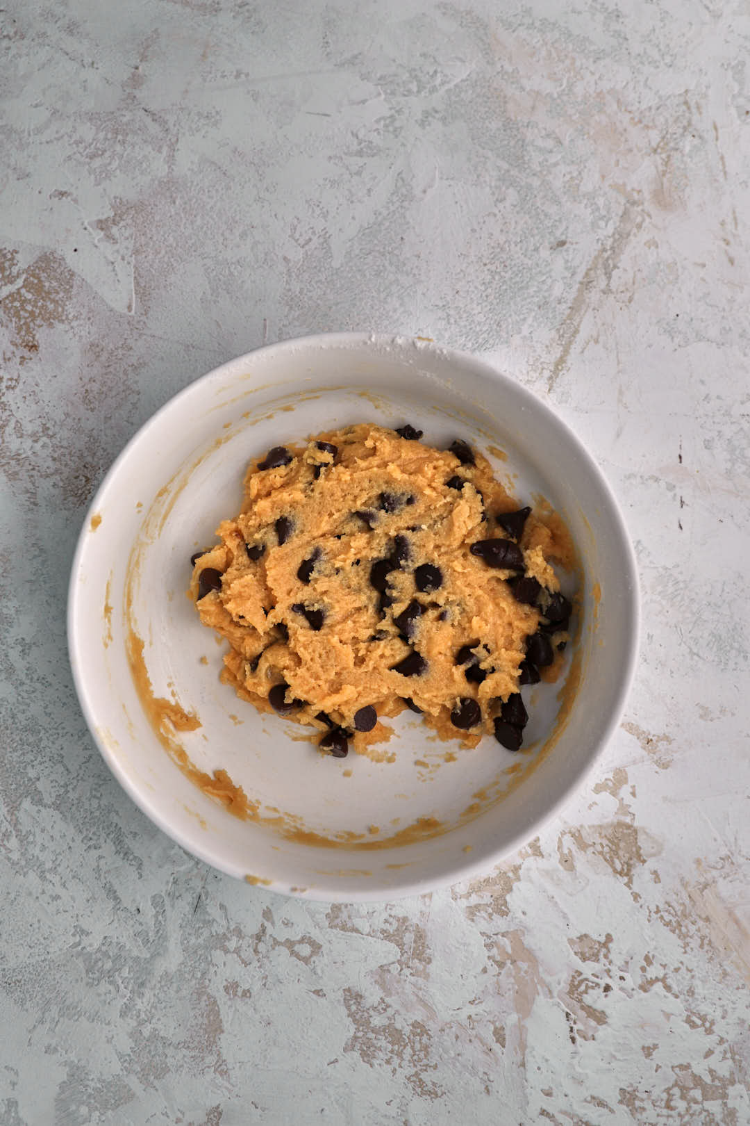 Chocolate chip cookie dough for two in a small bowl.