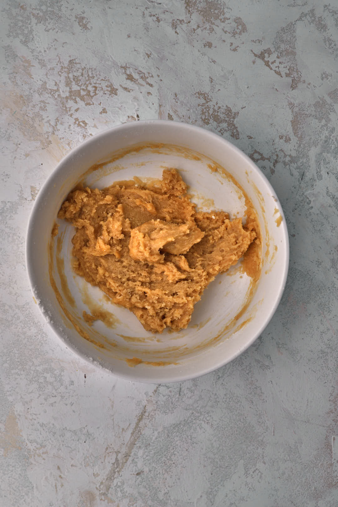 Two person cookie dough mixed together in small bowl.