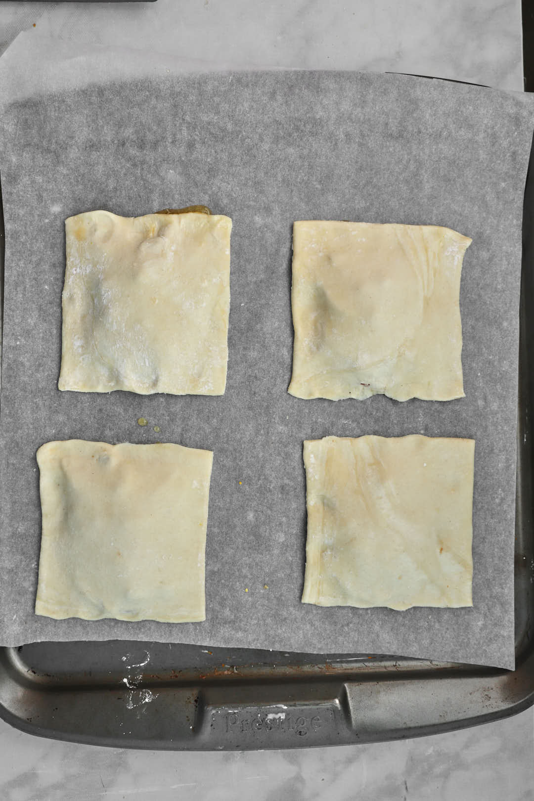 puff pastry squares evenly spaced apart onb aking sheet.