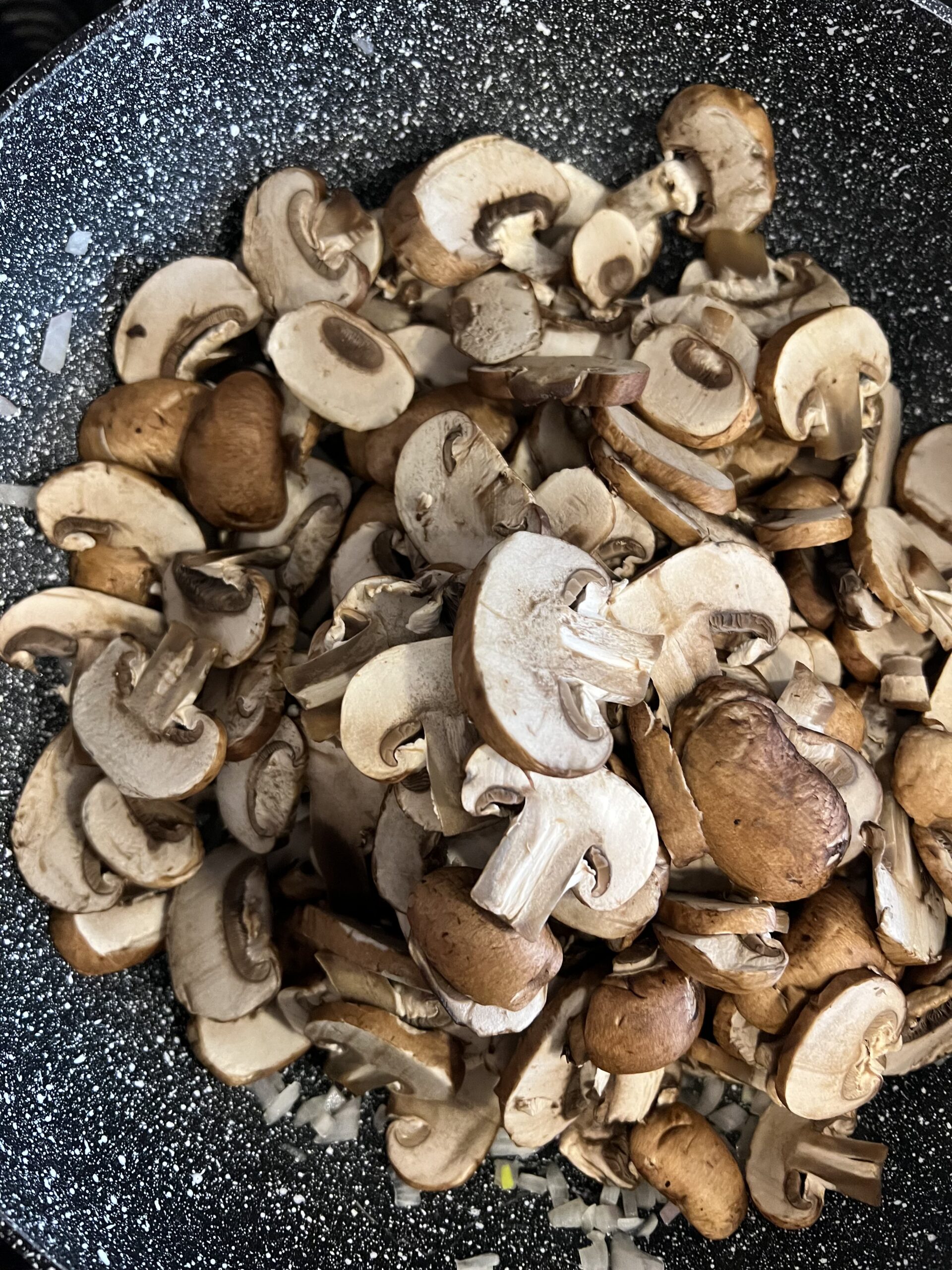 sliced mushrooms in a large skillet.