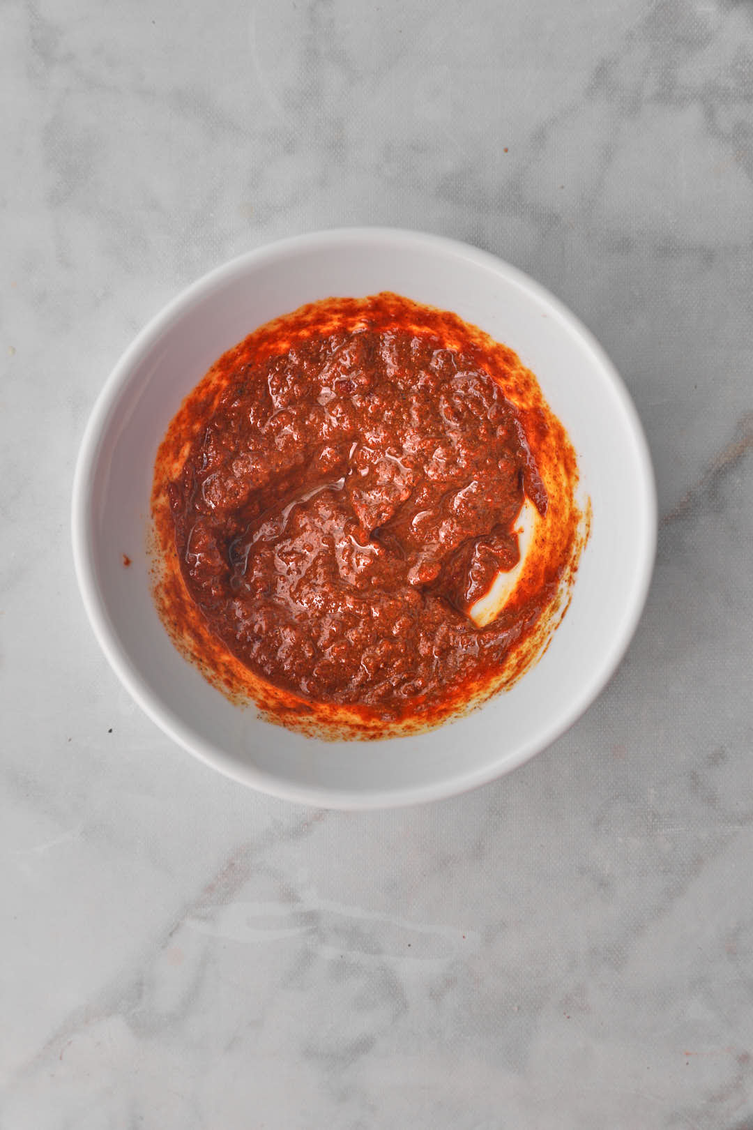 red pepper paste in a white bowl.