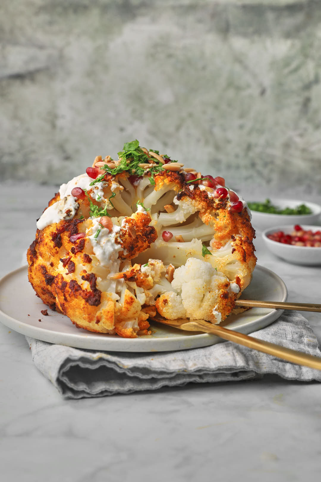 whole roasted tahini caulilflower being served.