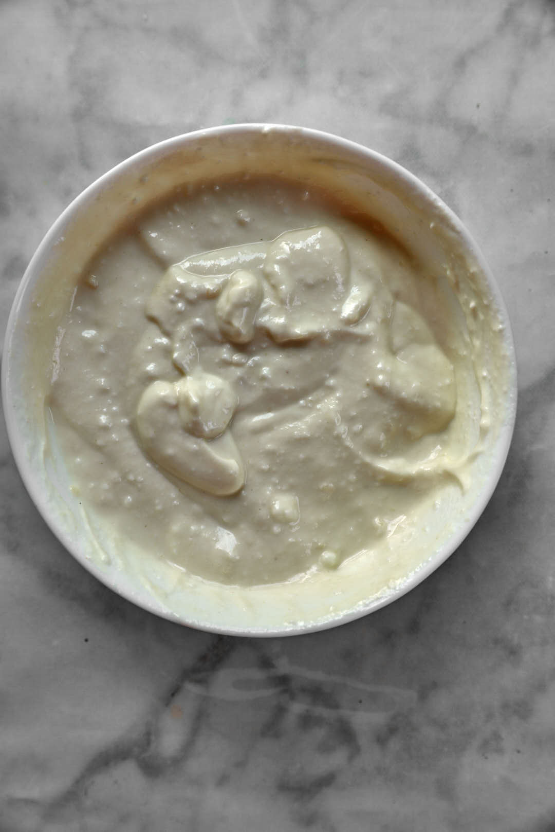 tahini yogurt sauce in white bowl.